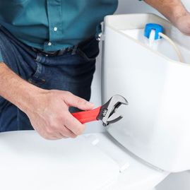 plumber fixing a toilet